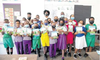  ?? CONTRIBUTE­D ?? Ancella Brown-Hardware (centre), Sagicor Life financial advisor, with third graders and Practising Teacher Jullisa Murray (left, back row) at the Crescent Primary School in St Catherine after reading with them on Read Across Jamaica Day. In addition to story and compositio­n books, the Sagicor Foundation also provided a new whiteboard to the classroom.