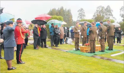  ??  ?? Cpl Tim Cook of NZ Army Band plays the Last Post as the casket is lowered.