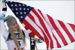  ?? GIOVANNI AULETTA — THE ASSOCIATED PRESS ?? Third place finisher Lindsey Vonn celebrates on the podium after the women’s downhill race, at the alpine ski World Championsh­ips in Are, Sweden, Sunday.