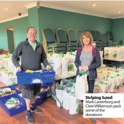  ??  ?? Helping hand Mark Lauterburg and Clare Williamson pack some of the donations