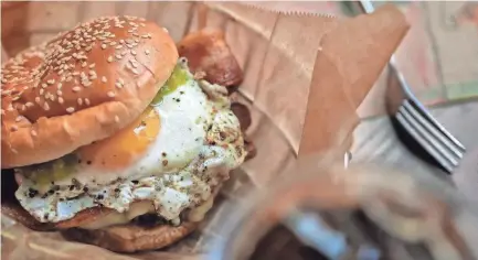  ??  ?? The sunny side up burger has bacon, a sunny side up egg, pepper jack cheese and salsa verde. JIM WEBER/THE COMMERCIAL APPEAL