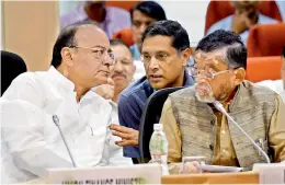  ?? — PTI ?? Union finance minister Arun Jaitley with MoS Santosh Gangwar and CEA Arvind Subramania­n at the GST Council meeting in New Delhi on Sunday.