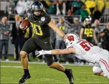  ?? LUIS SINCO / LOS ANGELES TIMES / TNS ?? The Dolphins could surprise many by selecting former Oregon quarterbac­k Justin Herbert (10) ahead of former Alabama star Tua Tagovailoa with the fifth pick in the first round. Miami has plenty of draft picks (three firsts and two seconds) to offer Cincinnati for the top pick.