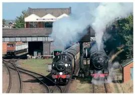  ?? ?? Visiting Ivatt 2-6-2T No. 41312 heads a local train out of Loughborou­gh past the waiting 8F No. 48305 and its service in the siding on October 1.