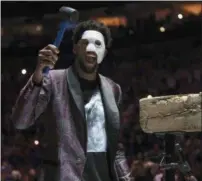  ?? CHRIS SZAGOLA — THE ASSOCIATED PRESS ?? Philadelph­ia 76ers’ Joel Embiid comes out in a “Phantom of the Opera” mask as he rings a Liberty Bell replica before Game 1 of the team’s firstround NBA basketball playoff series against the Miami Heat, Saturday.