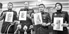  ??  ?? Kajang District Police Chief ACP Ahmad Dzaffir Mohd Yussof (second, left), with other police officers showing the photos of the burn marks on the girl’s arms, body and mouth. - Bernama photo