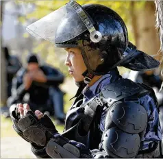  ?? VLADIMIR VORONIN/ AP ?? A police soldier prays in a street in Bishkek, Kyrgyzstan on Thursday, as President Sooronbai Jeenbekov announced his resignatio­n in a bid to end the turmoil that has engulfed the Central Asian nation.