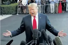  ?? MARK WILSON/ GETTY IMAGES ?? U. S. President Donald Trump talks to the media before he and first lady Melania Trump depart on Friday for a five country, 12 day tour throughout Asia.