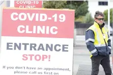  ?? — AFP file photo ?? A security guard stands outside a coronaviru­s clinic in Lower Hutt, near Wellington.