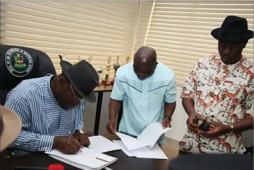 ??  ?? Governor Seriake Dickson (left), Clerk of the Assembly, Mr. Aaron Timiye and Speaker, Kombowei Benson, during the former's signing of the Education Safety Corps Law, 2017...recently