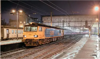  ?? DAVE MCALONE. ?? Running 39 minutes late, GB Railfreigh­t 92028 stands at Carlisle on March 5, with the 2328 London Euston-Glasgow Central/Edinburgh Waverley. This was the first northbound Sleeper to cross the border since Wednesday February 28, owing to heavy snowfall...