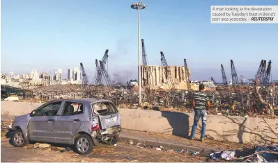  ??  ?? A man looking at the devastatio­n caused by Tuesday’s blast in Beirut’s port area yesterday. – REUTERSPIX