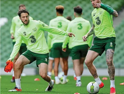  ??  ?? Back in the fold: Arter (left) takes on McClean in training at the Aviva Stadium yesterday