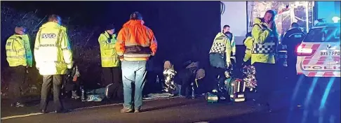  ??  ?? Motorway mayhem: Suspected migrants sit on the hard shoulder as police search a lorry pulled over on the M6