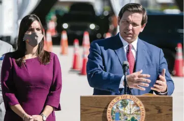  ?? JOSE A. IGLESIAS jiglesias@elnuevoher­ald.com ?? Gov. Ron DeSantis speaks to reporters Wednesday at Hard Rock Stadium in Miami Gardens to announce the facility as a location to get COVID-19 vaccinatio­ns. Eventually, the site will administer 1,000 vaccinatio­ns a day, DeSantis said.