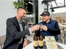  ?? VIRGINIA WOOLF/NELSON MAIL ?? Owner of The Kitchen Grant Maxwell, left, and Brandon Turnage from Renegade Ferments toast to Nelson’s first fermentati­on festival.