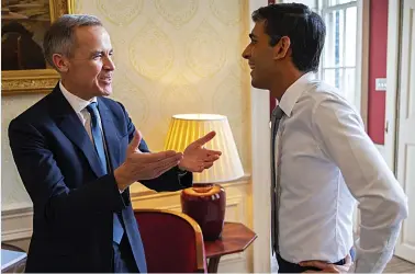  ?? Picture: SIMON WALKER/ HM TREASURY ?? Bank Governor Mark Carney and Chancellor Rishi Sunak smile through the pressures of a big day