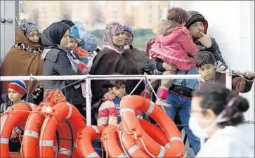  ?? Francesco Malavolta Associated Press ?? RESCUED MIGRANTS wait to leave a vessel in Porto Empedocle, Italy. More than 900 were saved in the latest rescue operation as 10 drowned. Last year, more than 3,000 migrants drowned trying to reach Italy.