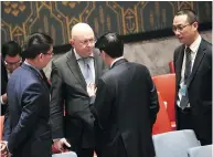  ?? DREW ANGERER / GETTY IMAGES ?? Vasily Nebenzya, second from left, Russian ambassador to the UN, speaks with Wu Haitao, Chinese deputy ambassador to the UN, in New York City on Thursday.