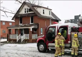 ?? The Canadian Press ?? Firefighte­rs pack up after responding to a house fire in Oshawa, Ont. on Monday. Two adults and two children were killed in the blaze that also sent three other people to hospital.