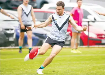  ?? ?? Trav Davis boots the ball forward for Yarragon.