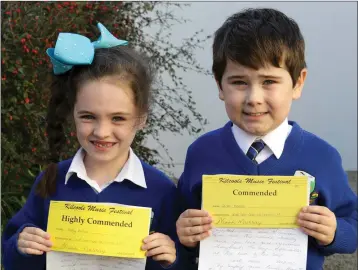  ??  ?? Ruby Devlin and Conor Morris who were highly commended and commended in the Corn na Leanaí at the at the Kilcoole Music Festival.