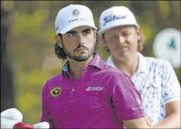  ?? David J. Phillip The Associated Press ?? Mexico’s Abraham Ancer, left, who is four shots behind the leader, is a Masters rookie, as is South Korea’s Sungjae Im, also four strokes back.