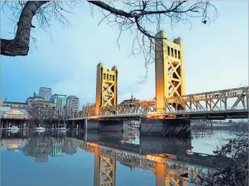  ?? Luis Sinco Los Angeles Times ?? COSTS ARE far less in Sacramento. A San Francisco software engineer could take a 50% salary cut moving to Sacramento and still have 20% more disposable income. Above, a view over the Sacramento River in 2013.