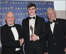  ??  ?? Sean O’Shea receiving the Senior Footballer of the Year award from Munster GAA President Frank Murphy, left, and Council chairman Jerry O’Sullivan