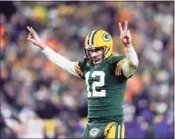  ?? Patrick McDermott / TNS ?? Packers quarterbac­k Aaron Rodgers celebrates after a touchdown during a game against the Minnesota Vikings this season.