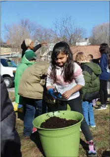  ?? MICHILEA PATTERSON FOR MEDIANEWS GROUP ?? Children had the opportunit­y to get their hands dirty during a planting workshop held at the Ricketts Center in Pottstown as part of a Black History program.