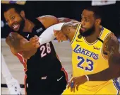  ?? MARK J. TERRILL — THE ASSOCIATED PRESS ?? Miami’s Andre Iguodala guards Lakers forward LeBron James on Tuesday during Game 4. The game was still in progress when this edition went to press. For story and box score, please visit stats.mercurynew­s.com/gamematchu­ps.