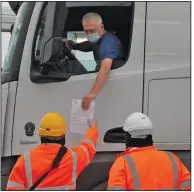  ?? (AP/Frank Augstein) ?? A truck driver’s documents are checked Friday at the Eurotunnel in Folkestone, England, that connects Great Britain to France.