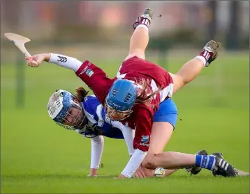  ??  ?? Aisling Cronin takes a tumble over Inniscarra’s Erin Looney.