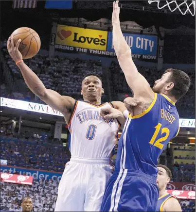  ?? AP/SUE OGROCKI ?? Oklahoma City guard Russell Westbrook (left) shoots as Golden State center Andrew Bogut defends during the first half of Sunday’s game. Westbrook finished with 30 points, 8 rebounds and 12 assists as the Thunder handed the Warriors a 133-105 defeat and...