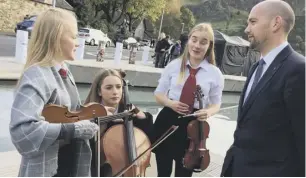  ??  ?? 0 MSPS Keiza Dugdale and Ben Macpherson meet music school pupils as parliament­arians joined the protests outside Holyrood, top