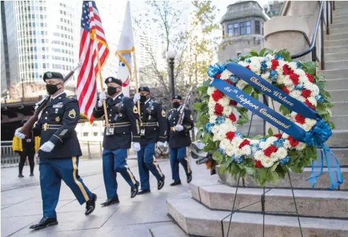  ?? ANTHONY VAZQUEZ/ SUN- TIMES ?? An Army Color Guard presents colors Wednesday during a Veterans Day ceremony held by the Chicago Wolves hockey team and the Arlington Heights- based 85th U. S. Army Reserve Support Command at the Vietnam Veterans Memorial on the Chicago Riverwalk.