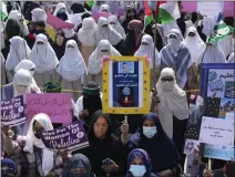  ?? K.M. CHAUDARY — THE ASSOCIATED PRESS ?? Women supporters of a religious party Jamaa-e-Islami take part in a rally to mark the Internatio­nal Women's Day in Lahore, Pakistan, Friday.