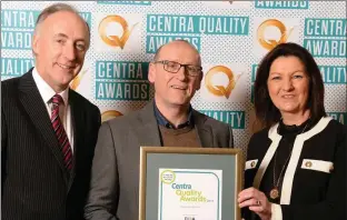  ??  ?? Albert O’Callaghan (centre), O’Callaghan’s Centra, Enniscorth­y, receives the Q Mark award from Ray Bowe, Head of Food Safety &amp; Quality, Centra, and Soraid McEntee, Operations Manager, EIQA.