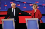  ?? PAUL SANCYA - THE ASSOCIATED PRESS ?? Sen. Bernie Sanders, I-Vt., gestures toward Sen. Elizabeth Warren, D-Mass., during the first of two Democratic presidenti­al primary debates hosted by CNN Tuesday, in the Fox Theatre in Detroit.