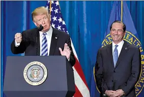  ?? AP/SUSAN WALSH ?? “Americans pay more so other countries can pay less. It’s wrong. It’s unfair,” President Donald Trump, with Health and Human Services Secretary Alex Azar at his side, said Thursday.