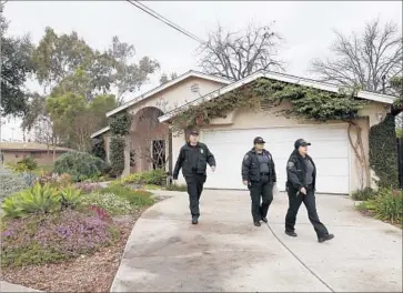  ?? Allen J. Schaben Los Angeles Times ?? POLICE officers leave the house on West 11th Street in Pomona where Monday’s fatal shooting occurred. It was the second time the house had been shot at in the last three weeks. No one was hit in the first attack.