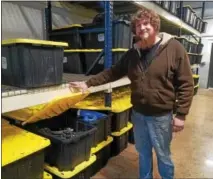  ?? DONNA ROVINS — DIGITAL FIRST MEDIA ?? Dan Samanen of Scavenger Cycles shows one of the storage bins the company uses to store motorcycle parts. Each bin contains the parts from one motorcycle the company buys, which is then taken apart to await a request from a client looking for a...