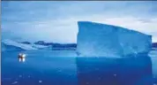  ??  ?? A file photo of a boat navigating next to an iceberg in eastern Greenland.
AP