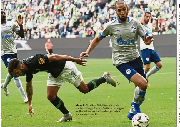  ??  ?? Move it: Schalke’s Nabil Bentaleb (right) and Wolfsburg’s Renato Steffen challengin­g for the ball during the Bundesliga match last weekend. — AP