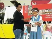  ?? Picture: DESMOND COETZEE ?? SILENCE IS GOLDEN: Schornvill­e Primary pupil Esona Diamond reads from Nelson Mandela’s ‘Long Walk to Freedom’ with department official Limisa Ketile during Library Week celebratio­ns in Breidbach