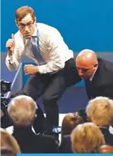  ?? —AFP ?? MANCHESTER: Protester comedian Simon Brodkin gives a thumbs-up towards Britain’s Foreign Secretary Boris Johnson (right).