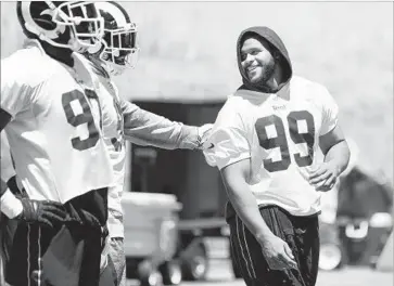  ?? Wally Skalij Los Angeles Times ?? DEFENSIVE LINEMAN Aaron Donald, right, missed the preseason and the first regular-season game because of a contract holdout. But he’ll start Sunday against Washington after practicing three times this week.