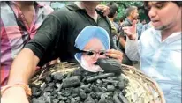  ??  ?? Activists hold a photo of Indian PM Manmohan Singh during a protest against the coal allocation controvers­y in August
