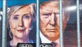  ?? AFP ?? Images of Hillary Clinton and Donald Trump are seen on a vehicle on Saturday at Hofstra University, in New York. The university is the venue of the first presidenti­al debate to be held on Monday.